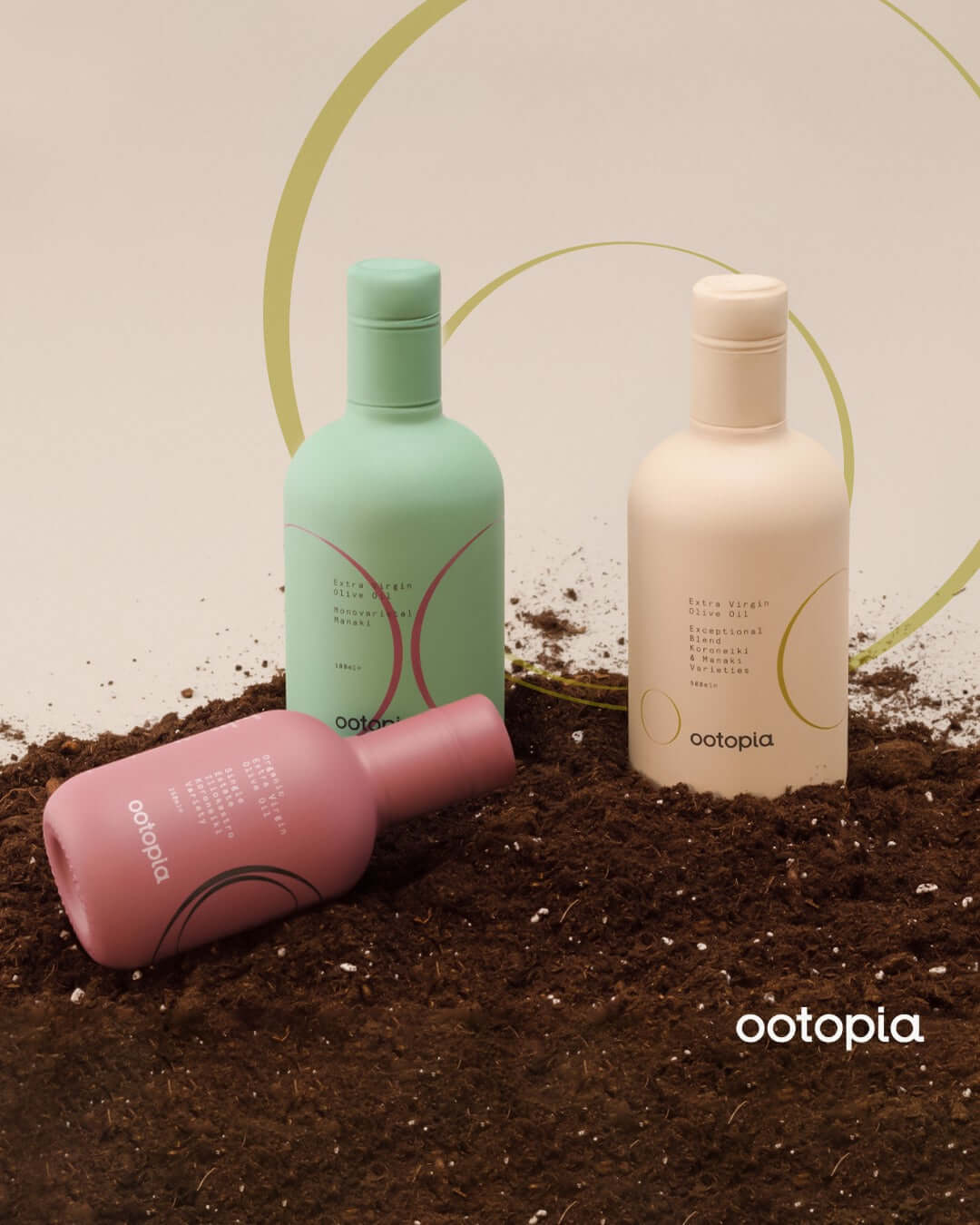 Three bottles of Ootopia superior quality extra virgin olive oil showcased against earthy background.